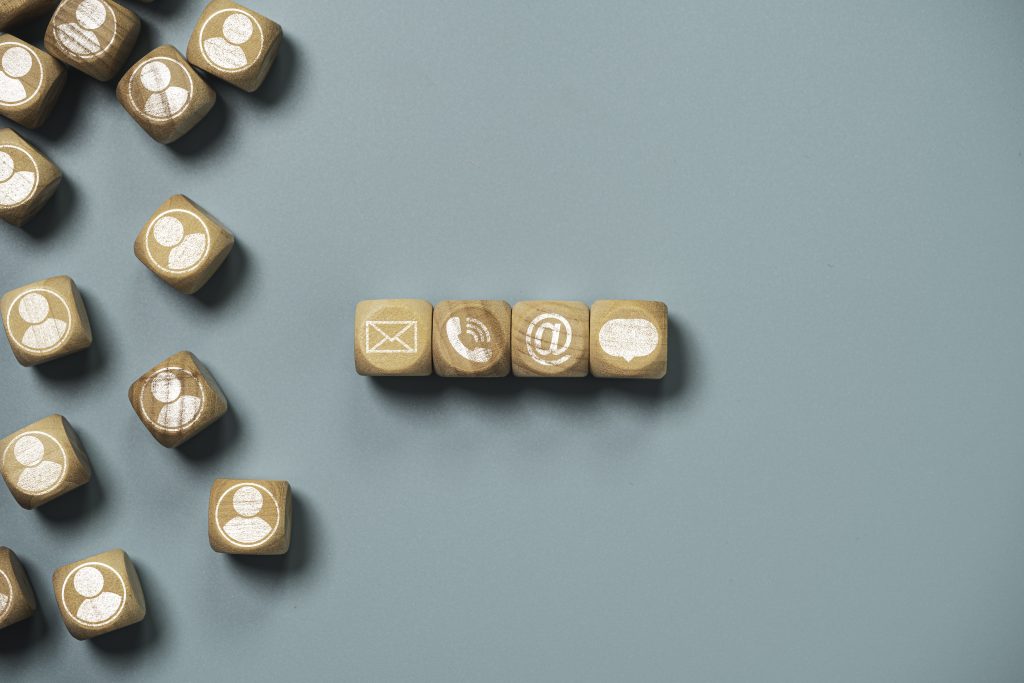 customer service and business contact concept, wooden cube block